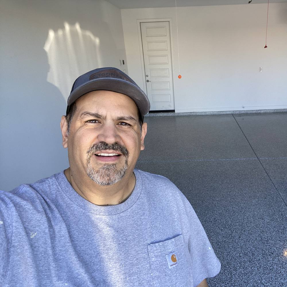Jose Gonzales at a finished garage floor coating job